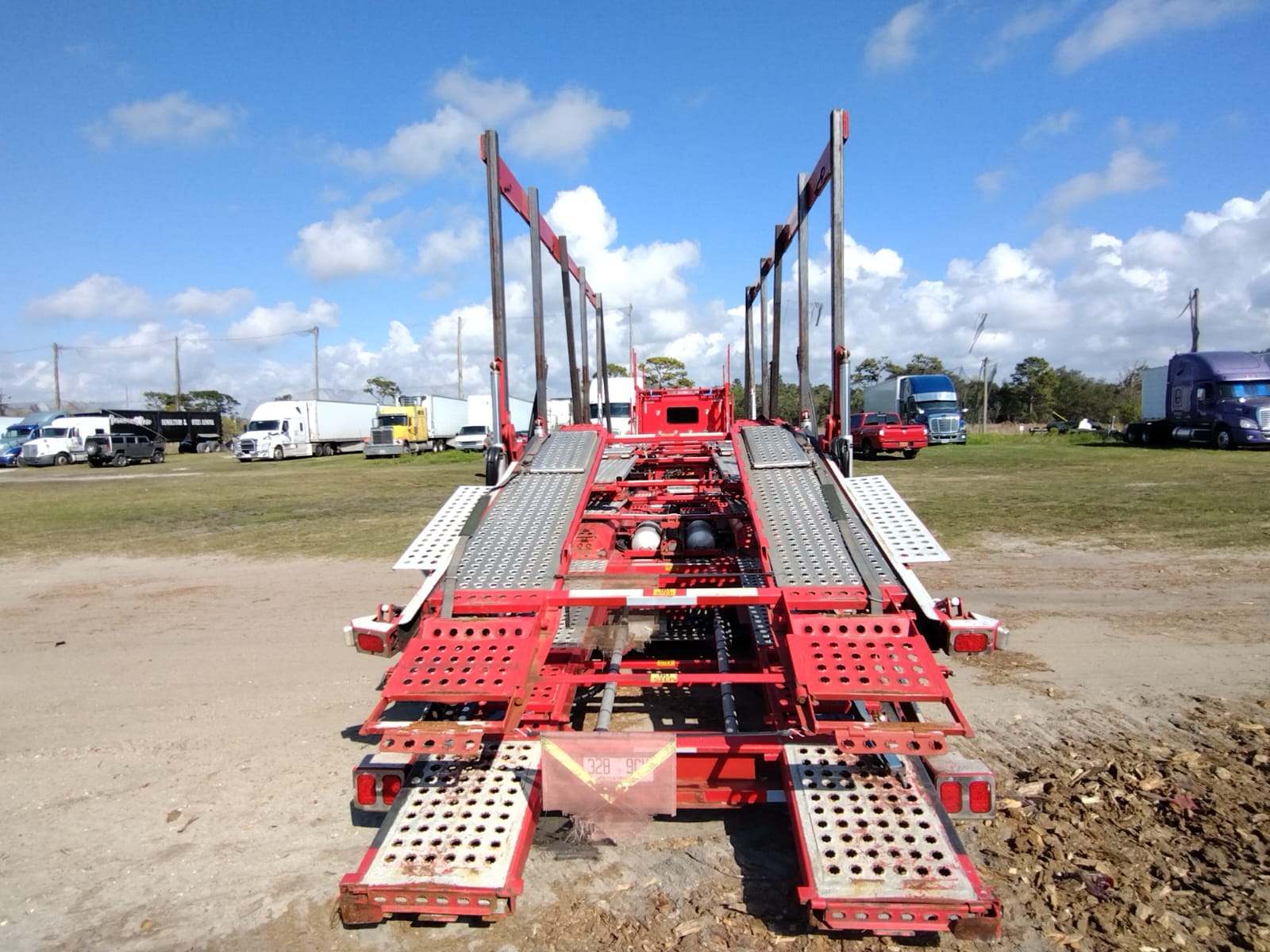 Vehicles secured on an automotive transport trailer